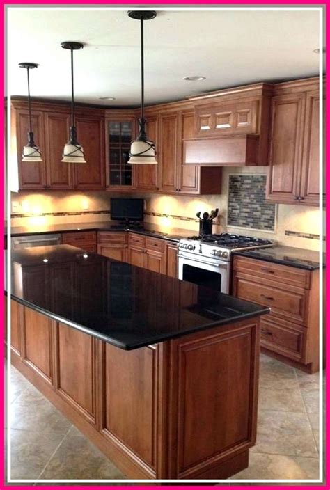 kitchen with stainless steel appliances and oak cabinets|oak cabinets with black hardware.